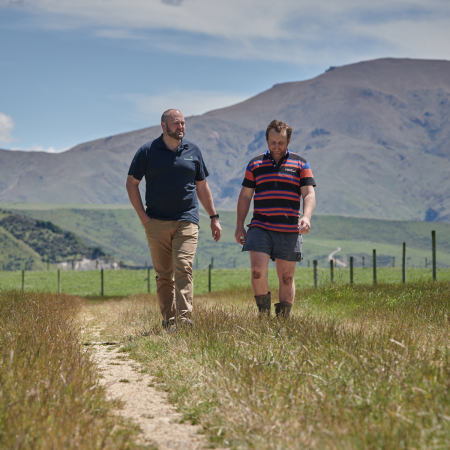 Meridian staff memeber walking with a farmer