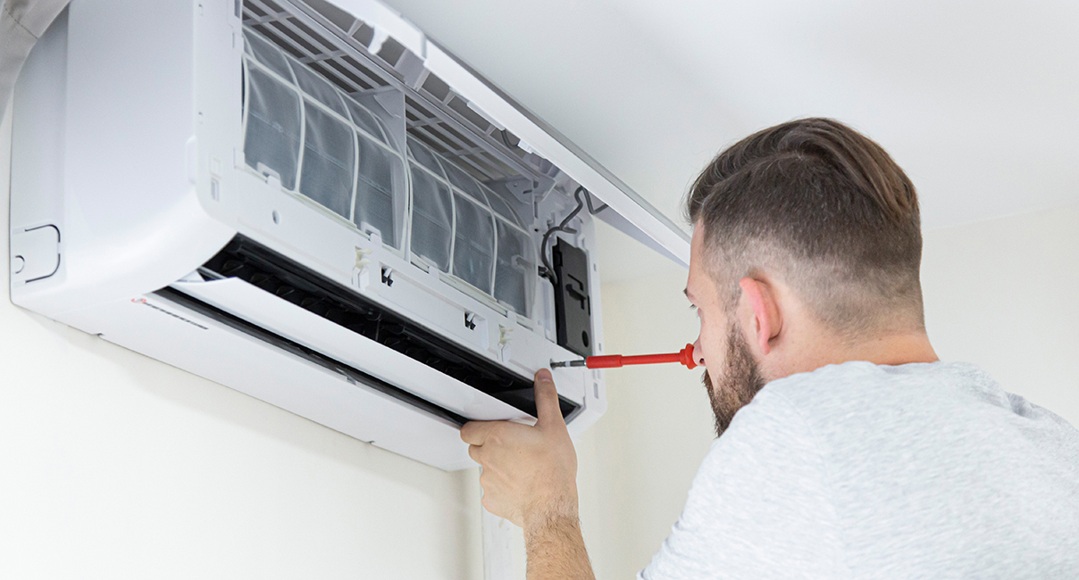 Man fixing a heat pump